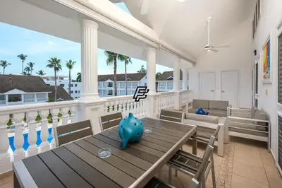 a dining room with a table and chairs on a balcony at Luxury Penthouse in front of the Sea in Las Terrenas in Las Terrenas
