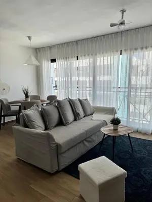 a living room with a couch and a table at Cozy Apt Steps from Los Corales Beach in Punta Cana