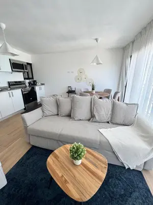 a living room with a couch and a table at Cozy Apt Steps from Los Corales Beach in Punta Cana
