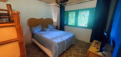 a small bedroom with a bed and a window at Studio surrounded by nature in Cabarete