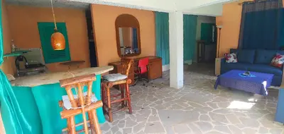 a living room with a bar and a couch at Studio surrounded by nature in Cabarete