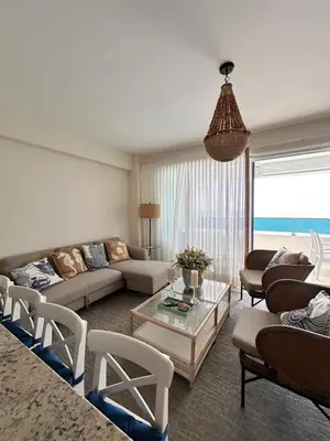 a living room with a couch and a table at Your oceanfront paradise in La Puntica de Juan Dolio