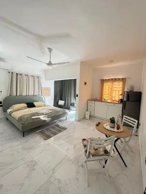 a large bedroom with a bed and a table at Nashaly suite in Arroyo El Cabo