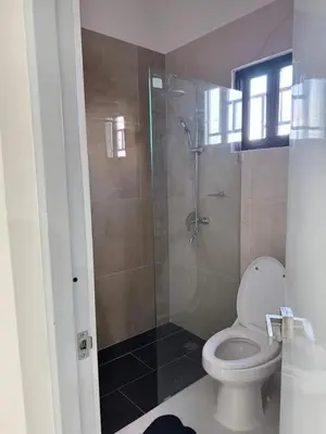 a bathroom with a toilet and a glass shower at Nashaly suite in Arroyo El Cabo