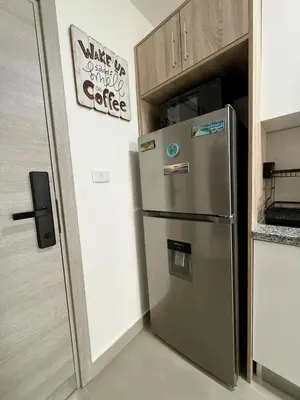 a refrigerator in a kitchen with a sign on the wall at Stay Caribbean Bayahibe Getaway in Bayahibe