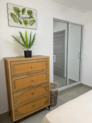 a bedroom with a dresser with a plant on it at Stay Caribbean Bayahibe Getaway in Bayahibe