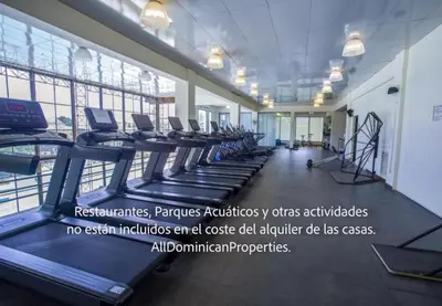 a gym with a row of treadmills and machines at Sosua Ocean Village, Villas 24 in Sosúa
