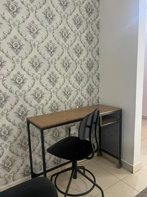 a desk with a chair in front of a wall at Burungos Place at Terrazas del Caribe in Ensanche Savica de Mendoza