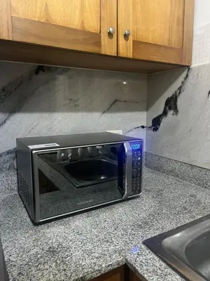 a toaster oven sitting on a counter in a kitchen at Burungos Place at Terrazas del Caribe in Ensanche Savica de Mendoza