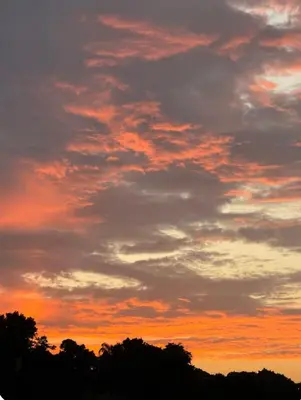 an orange sunset with clouds in the sky at Apartamento Luna Llena in Colorado
