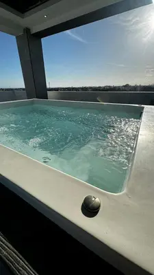 a hot tub with a rock in the water at Estancia Rincon del AMOR in Juan López