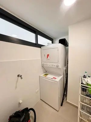 a small white refrigerator in a room with a window at Garden Suite Vista Golf E-105 in Colorado