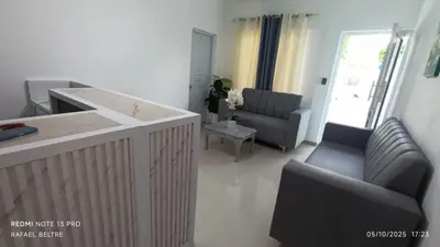 a kitchen and living room with two chairs and a counter at Remanso de Paz in Pedernales