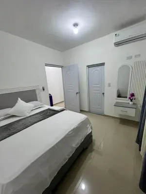 a white bedroom with a large bed and a window at Remanso de Paz in Pedernales