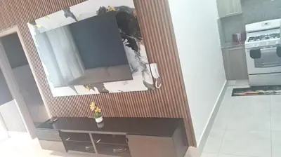 a tv hanging on a wall in a kitchen at Ocean Views Escape at DGM Resort in Boca Chica