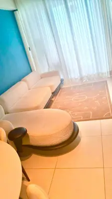 a living room with a couch and a table and chairs at Ocean Views Escape at DGM Resort in Boca Chica