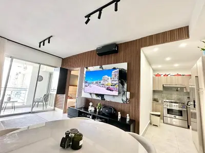 a living room with a flat screen tv on a wall at Ocean Views Escape at DGM Resort in Boca Chica