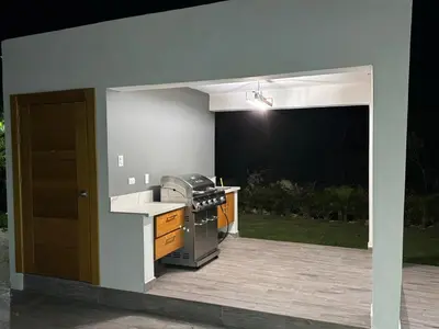 an outdoor kitchen with a stove and a patio at New villa with 4 bedrooms and 5 beds in La Romana
