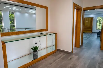 a room with a glass shelf and a mirror at Great villa with pool table in La Romana