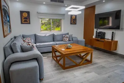 a living room with a couch and a coffee table at Great villa with pool table in La Romana