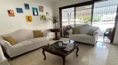 a living room with two couches and a coffee table at Cozy apartment in Piantini city center in Santo Domingo