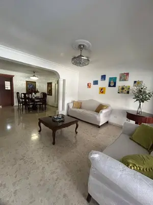 a living room with a couch and a table at Cozy apartment in Piantini city center in Santo Domingo
