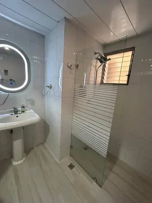 a bathroom with a shower and a sink at Cozy apartment in Piantini city center in Santo Domingo