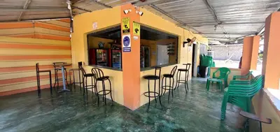 a bar with stools in a room with a counter at hotel las yayas la vega in Concepción de La Vega