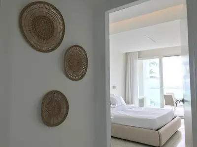 a bedroom with a bed and two baskets on the wall at Boca Beach Residence 304 in Boca Chica