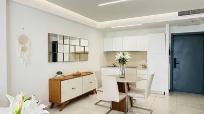a white kitchen with a table and a dining room at Boca Beach Residence 304 in Boca Chica