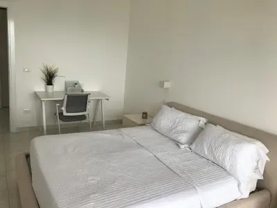 a white bedroom with a bed and a desk at Boca Beach Residence 304 in Boca Chica