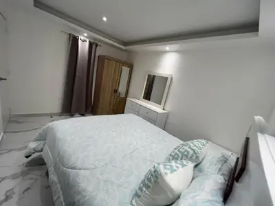 a bedroom with a large bed and a mirror at Boca Beach 504, Boca Chica in Boca Chica