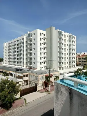 a view of two large white buildings with a swimming pool at Residential Boca del Mar Tower III Apart 802 in Boca Chica