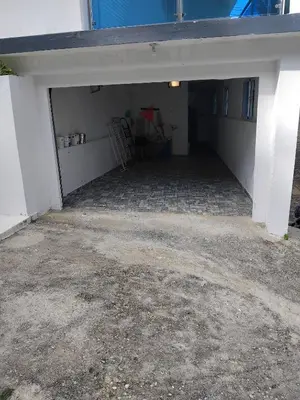 an empty garage with a table in it at Villa de Angela en Samana in Sabana