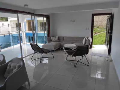 a living room with a couch and chairs at Villa de Angela en Samana in Sabana