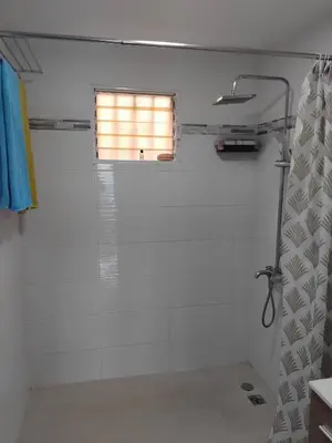 a bathroom with a shower and a window at Villa de Angela en Samana in Sabana