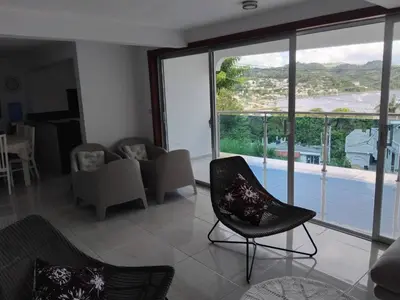 a living room with chairs and a large glass window at Villa de Angela en Samana in Sabana