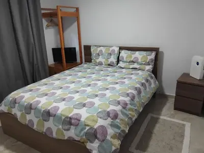 a bedroom with a bed with a colorful comforter at Villa de Angela en Samana in Sabana