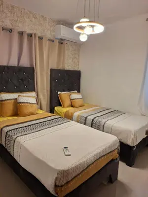 two beds sitting in a room with at Luna airport retreat in Boca Chica