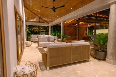 a patio with couches and tables and a ceiling at New! Gorgeous Portillo Beach Villa W Pool & Staff in Abra Grande