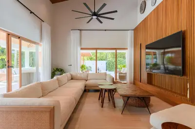 a living room with a couch and a tv at New! Gorgeous Portillo Beach Villa W Pool & Staff in Abra Grande