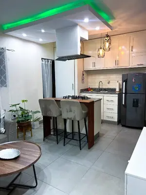 a kitchen with a kitchen island with bar stools at Colonial leyton apartment in Santo Domingo