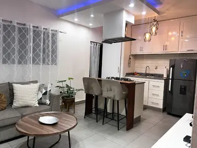a kitchen and living room with a couch and a table at Colonial leyton apartment in Santo Domingo