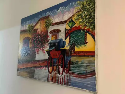 a painting hanging on a wall on a wall at Colonial leyton apartment in Santo Domingo