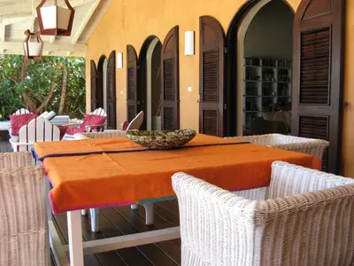 a table with chairs and a bowl on top of it at Villa Los Gorgones in Las Galeras