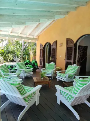 a group of lounge chairs on a deck at Villa Los Gorgones in Las Galeras