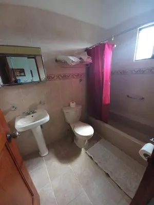 a bathroom with a toilet and a sink and a shower at Residencial Estephany in Sosúa