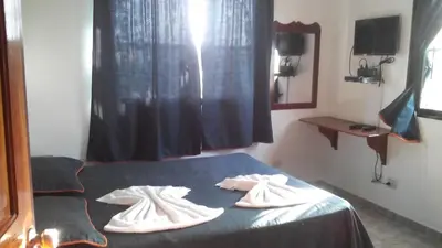 a bedroom with a bed with towels on it at Residencial Estephany in Sosúa