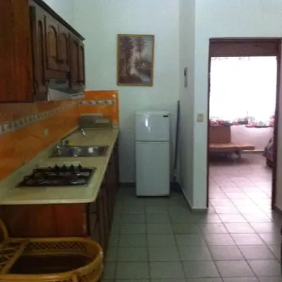 a kitchen with a sink and a refrigerator at Residencial Estephany in Sosúa