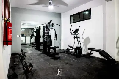 a gym with bikes and tread machines in a room at Fj Luxury Apartment in Santiago de los Caballeros